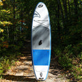 Paddleboard with blue and gray design on a forest path