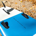 Close-up of a blue and white inflatable paddleboard with fins