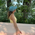 Side View of the girl wearing the Dad Hat Surf & Paddle in Dark Mint Color