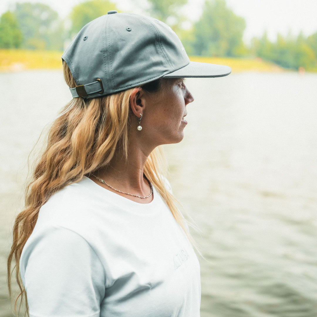 Side View of a girl wearing the Dad Hat Surf & Paddle in Grey