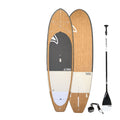 Wooden paddleboard with black paddle and leash on a white background