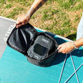 Person opening a carrying case of the battery pump
