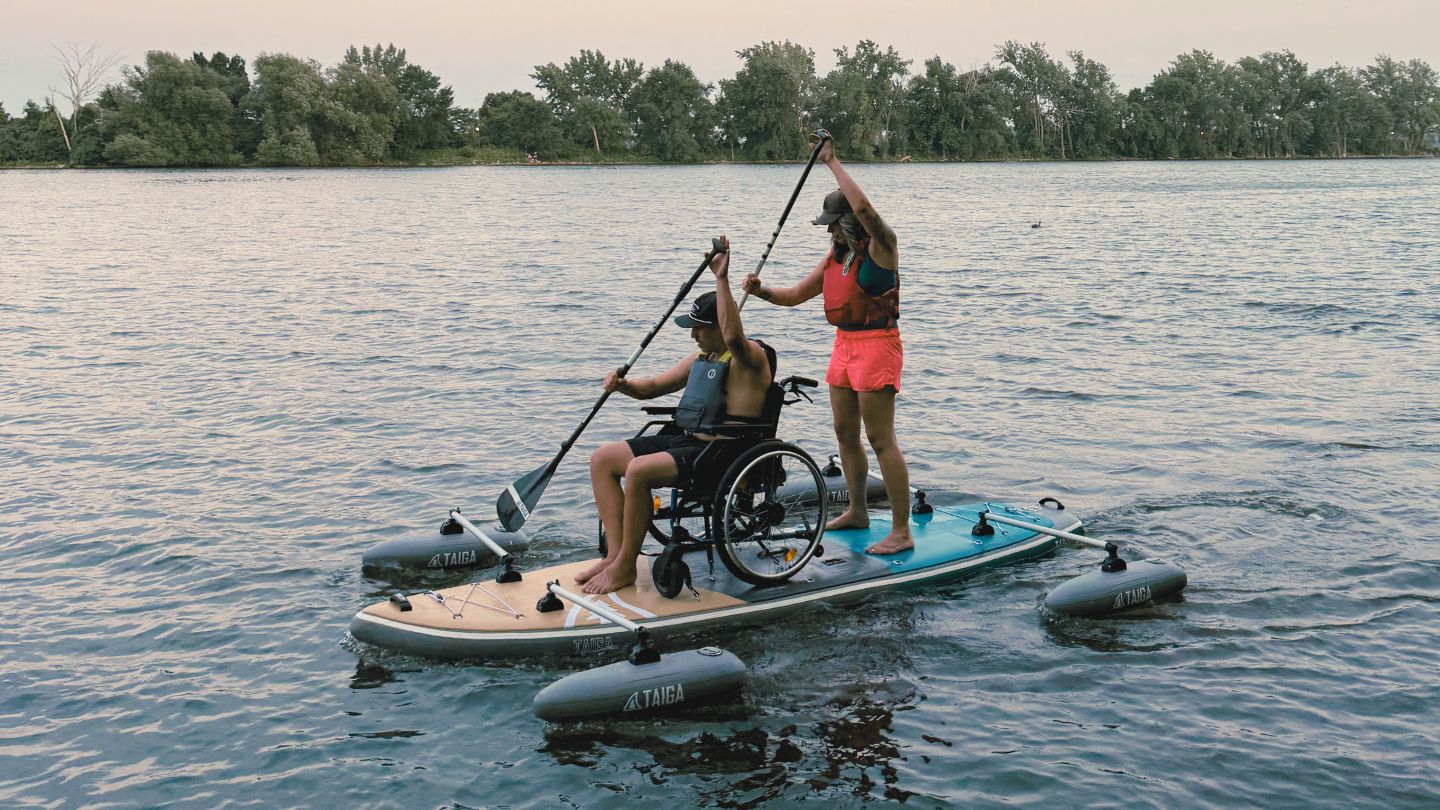 Two paddlers on the TAIGA Adaptive SUP