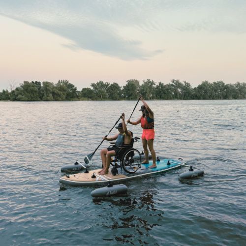 Two paddlers on the TAIGA Adaptive SUP