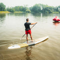 Paddler on a lake with the Kazuzu 12'6 Pine