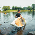 Paddler holding the Kazuzu 12'6 Pine
