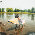 Paddler holding the Kazuzu 12'6 Dusty Pink