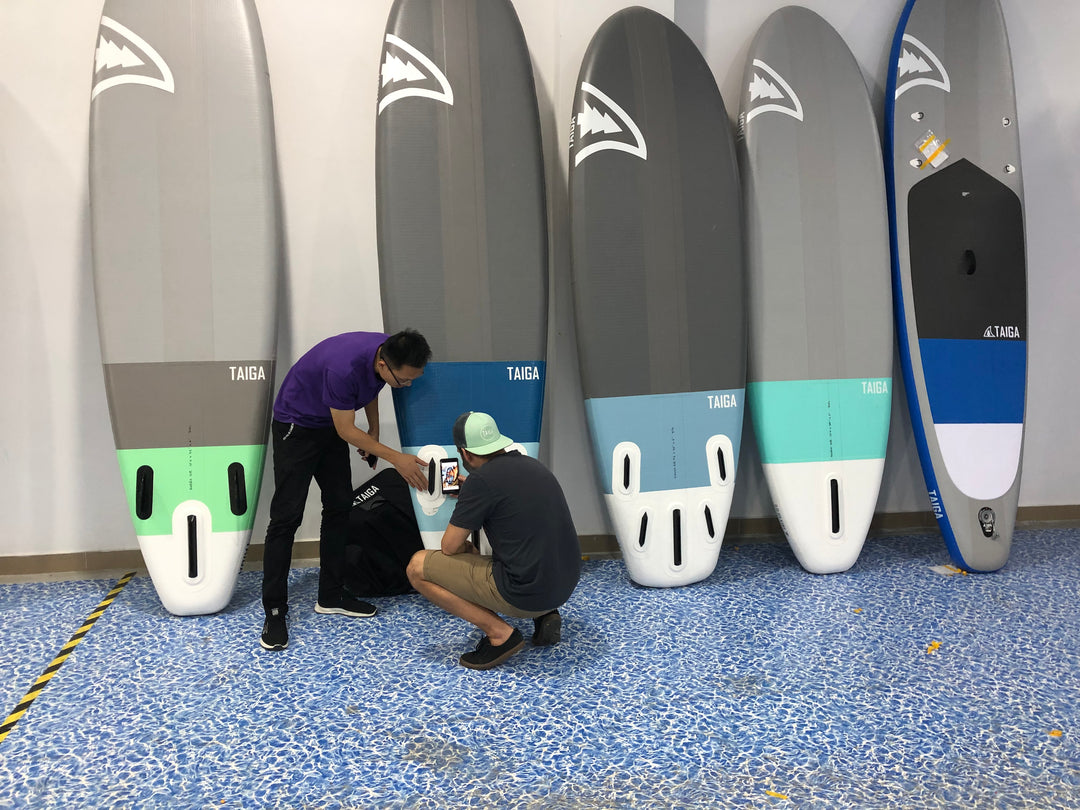 Two men looking at Inflatable Prototypes in SUP manufactury