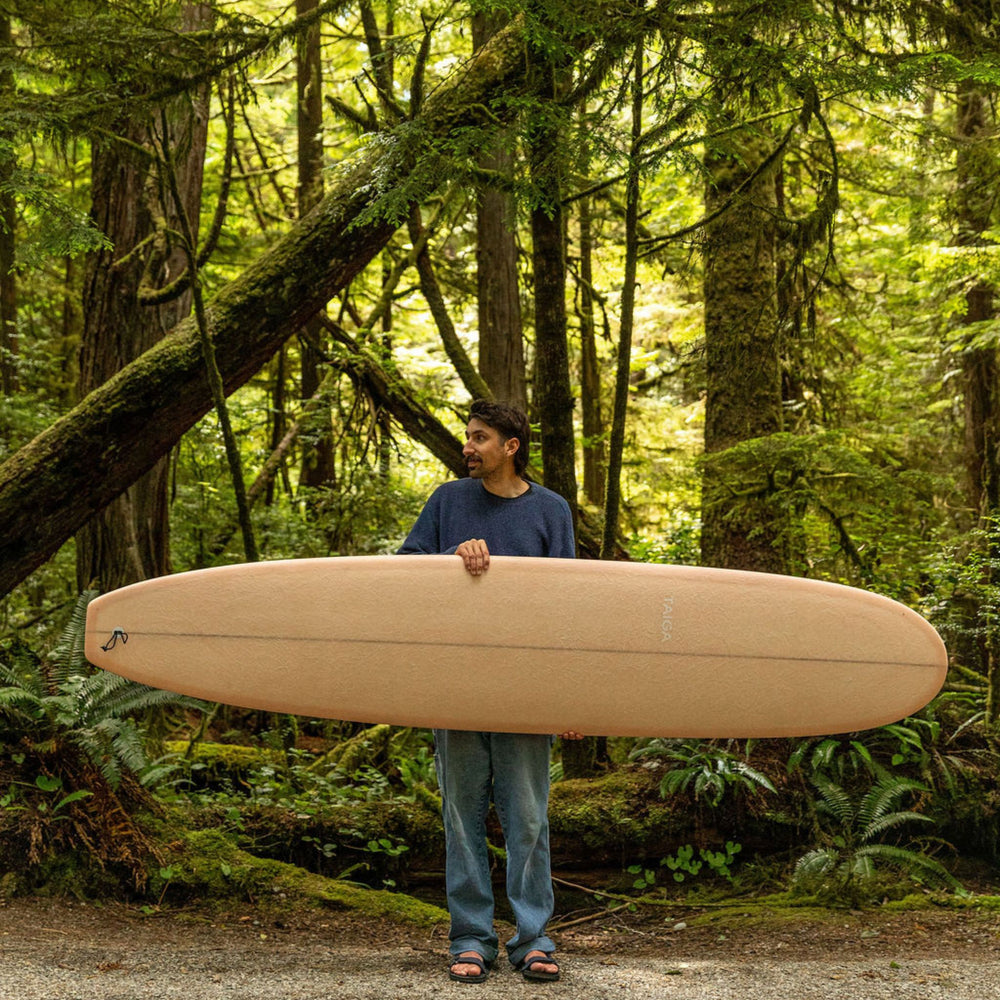 Guy Holding The Longboard Surf Board in The Rosé Color