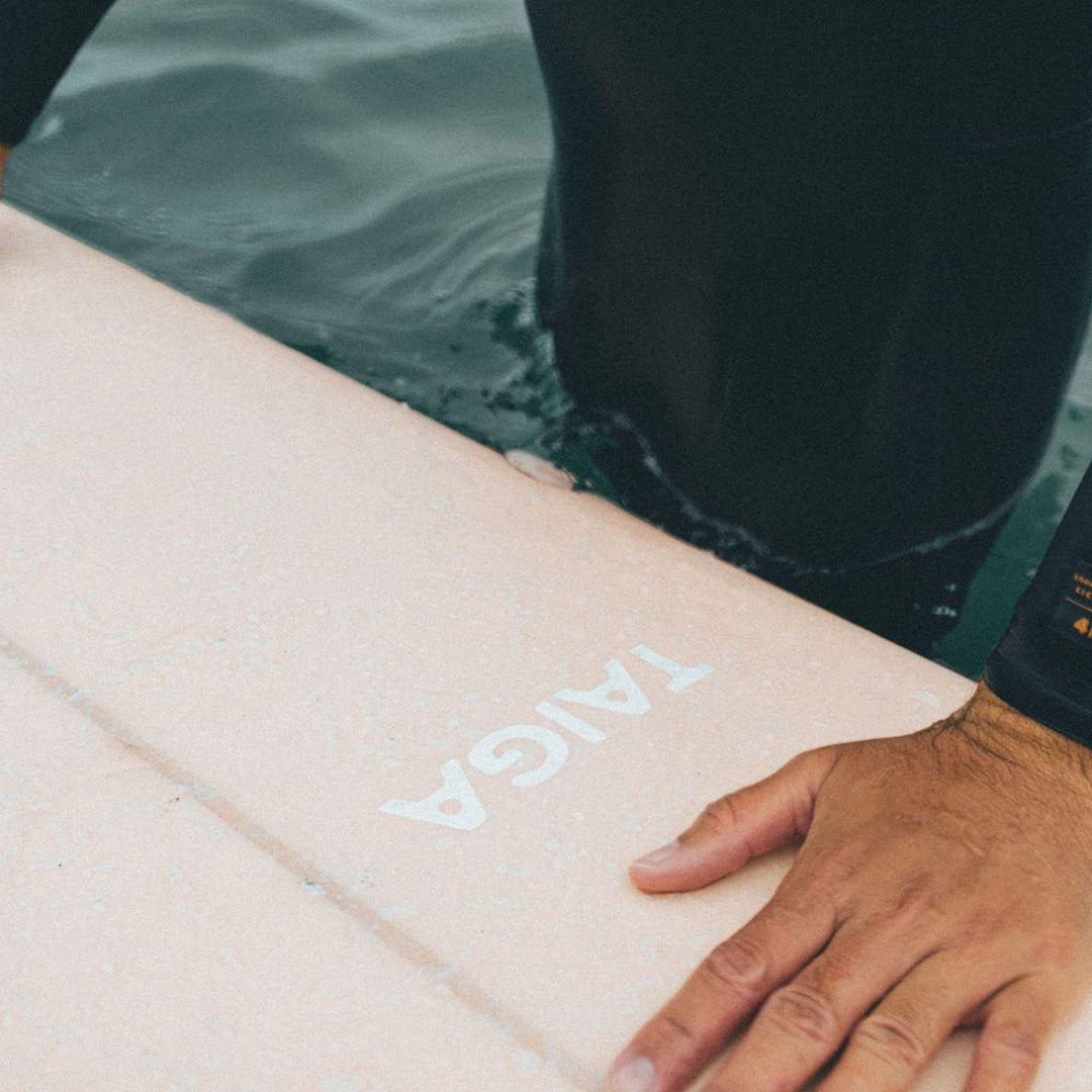 Guy Handling The Longboard Surf Board in The Rosé Color in The Ocean