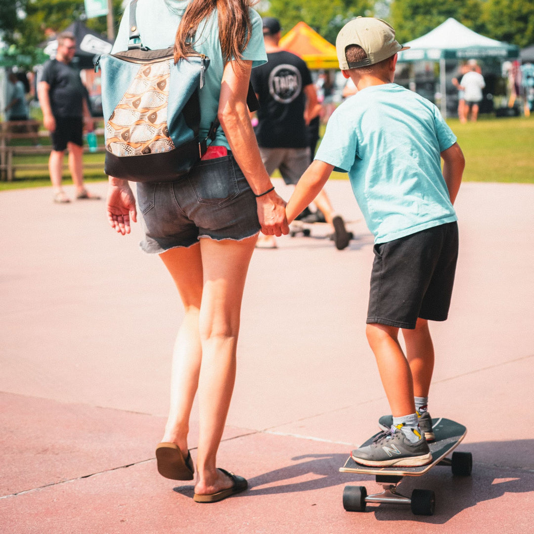 Kid skateboarding on the Surfskate By TAIGA with his mom