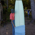 Person removing the surfsock of the longboard surf