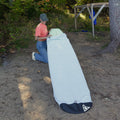 Person removing the surf sock of a longboard