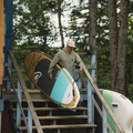 Paddler holding the Awen 10'0 Turquoise by TAIGA BOARD