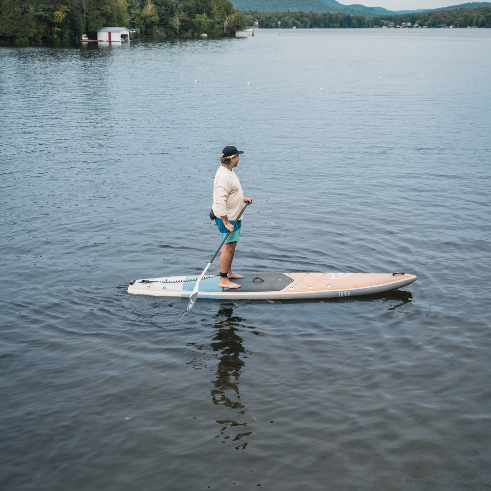 Paddler on a lake with the Kazuzu Air 12'6 blue