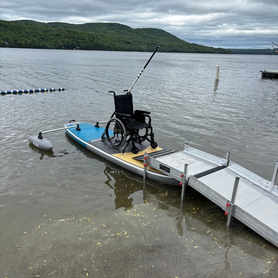Wheelchair on the TAIGA Adaptive SUP by a ramp on the lake
