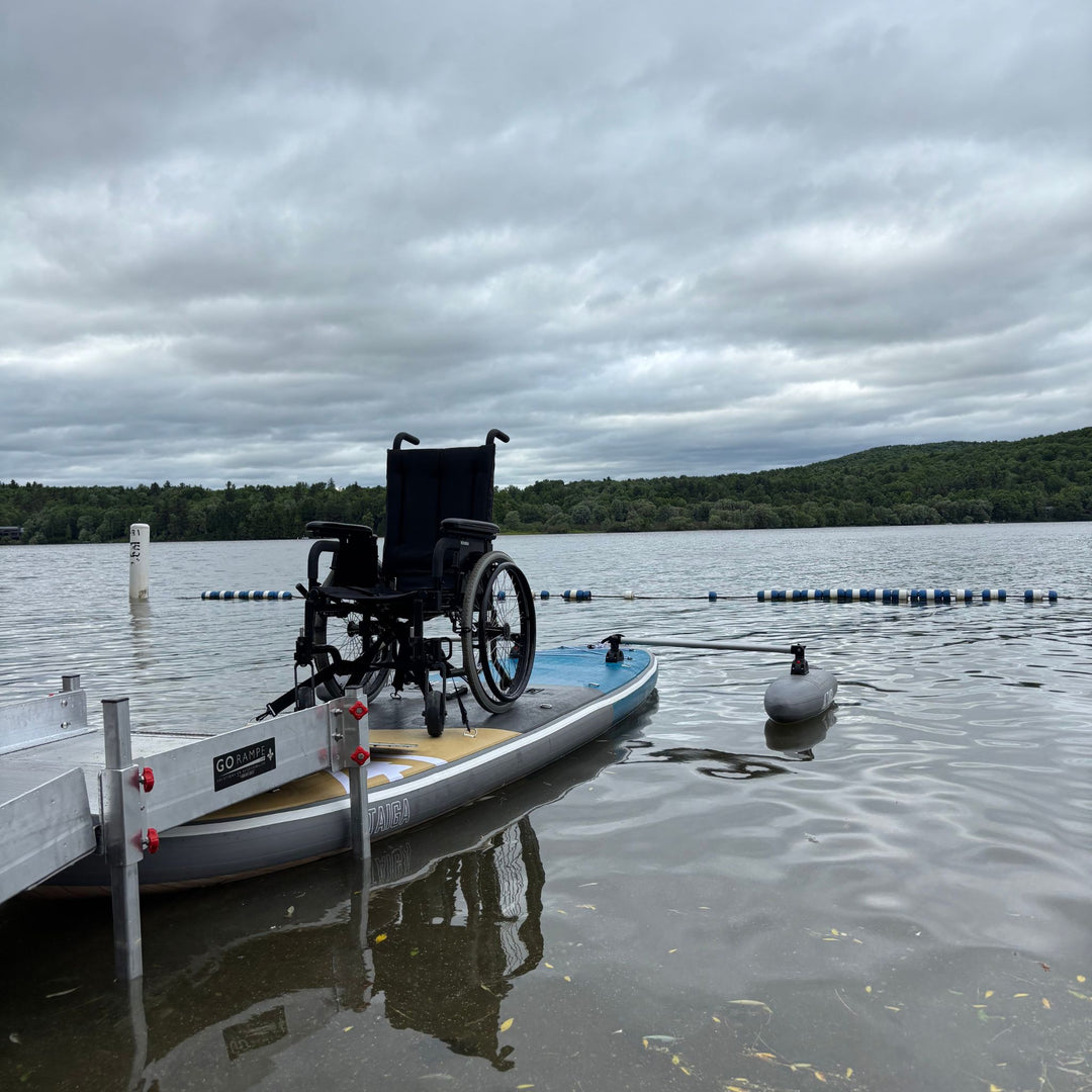 Wheelchair on the TAIGA Adaptive SUP by a ramp on the lake