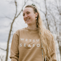 Girl wearing the WETSUIT SEASON CREWNECK - SAND