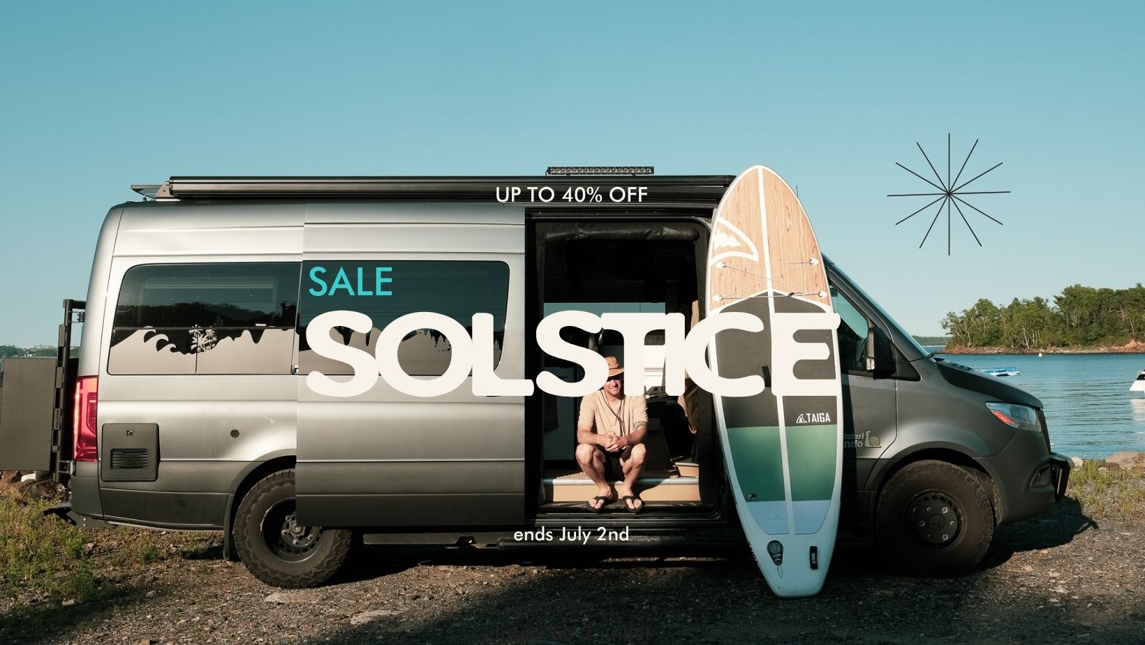 Van with 'Solstice' branding and a sale offer, next to a person with a paddle board by a body of water.
