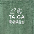 Green towel with 'TAIGA BOARD' text and logo on a green background