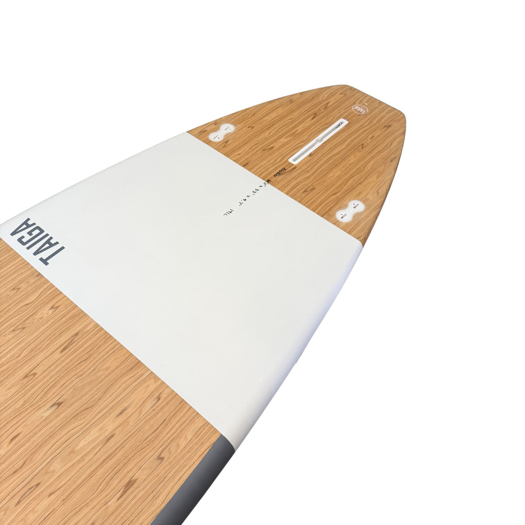 Wooden and white surfboard with 'TAIGA' branding on a white background