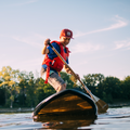 Kid wearing PFD Vest by MUSTANG - Red