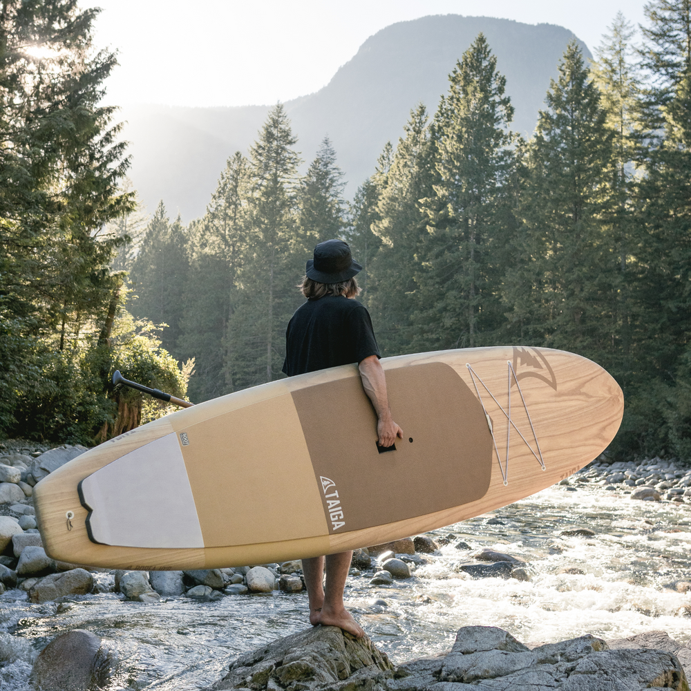 Paddler holding the Borea 10'6 - Root Collection
