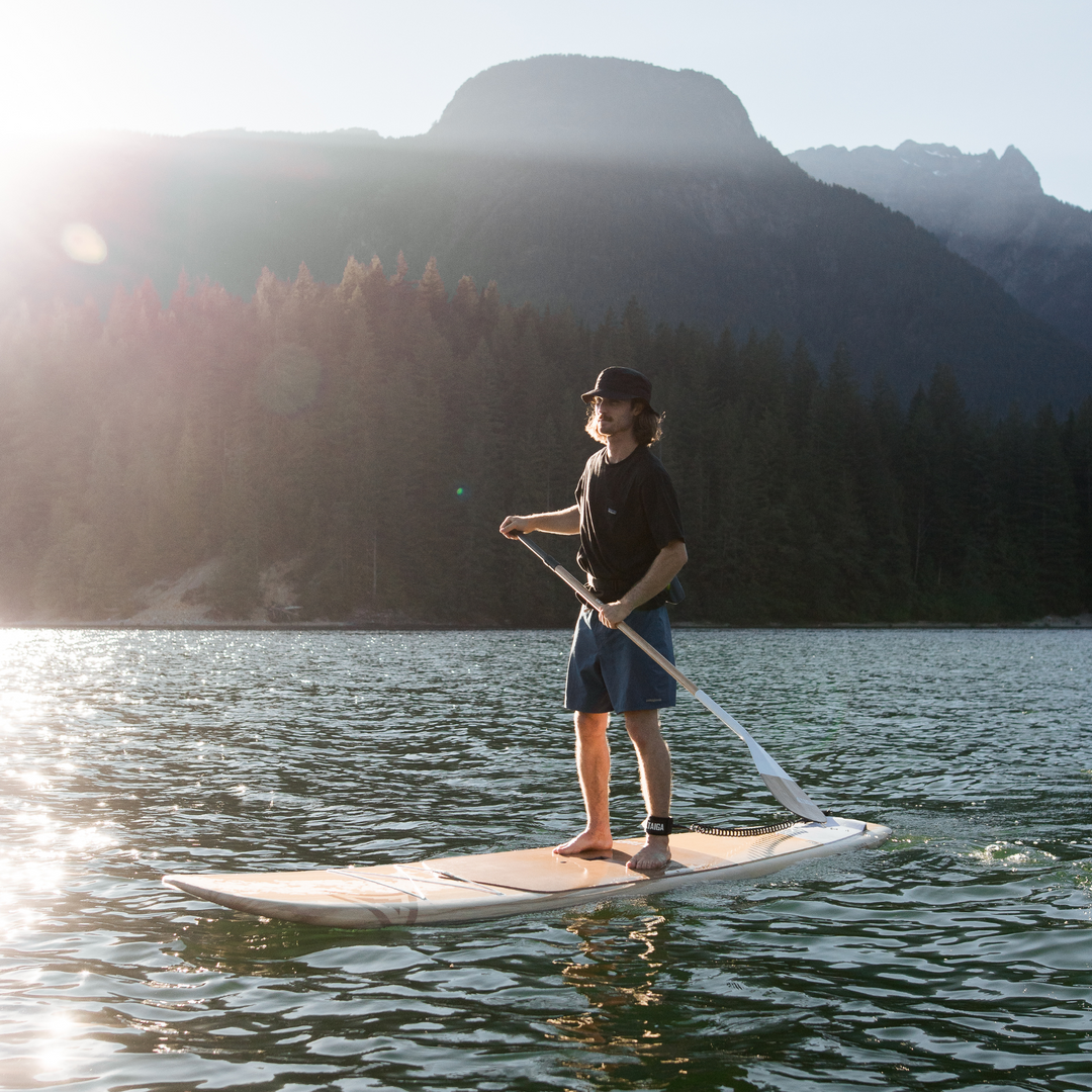Paddler on a lake with the Borea 10'6 - Root Collection