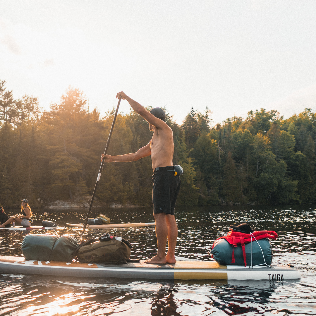 SUP camping - Paddler wearing the minimalist PFD Belt Pack by MUSTANG